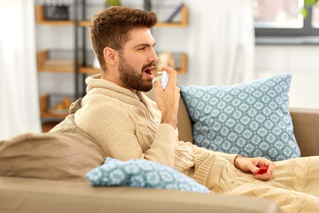 sildenafil oral spray - man in blanket using oral spray at home