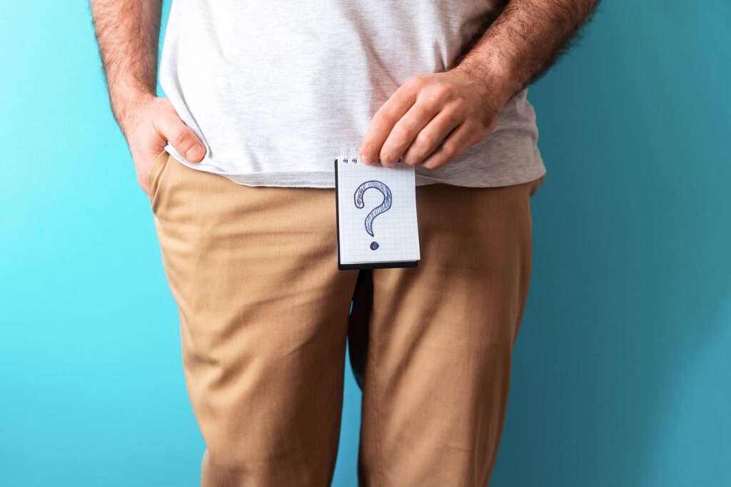buy sildenafil - man in beige jeans holds a notepad with question mark